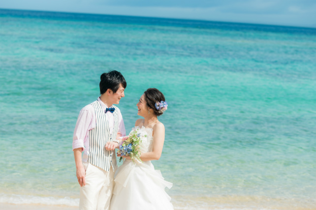 晴れ渡る空と海に包まれた沖縄のビーチにプリンセスドレスも素敵